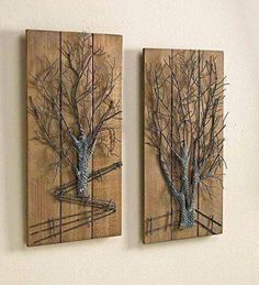 two wooden wall hangings with trees on them