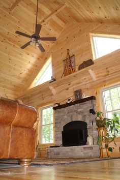 a living room filled with furniture and a fire place in the middle of a room