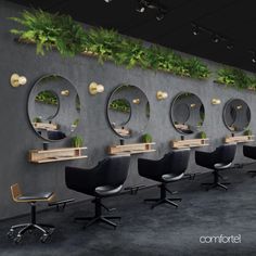 a row of chairs sitting next to each other in front of a wall with plants growing on it