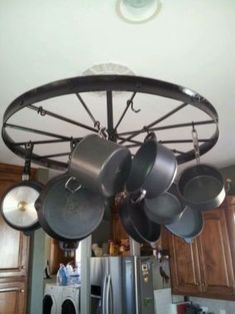 pots and pans are hanging from the ceiling