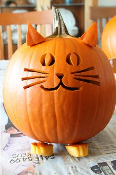 a cat pumpkin sitting on top of a table