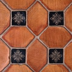 a close up view of a tile floor with different colors and designs on the tiles