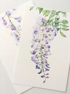 two cards with watercolor paintings of purple and white flowers, one on top of the other