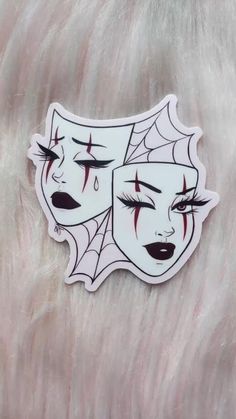 a white sticker with red eyes and spider webs on it's face