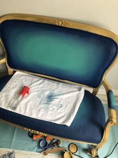 a blue chair with a white towel on it's back and other items around it