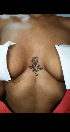 a woman with a rose tattoo on her stomach