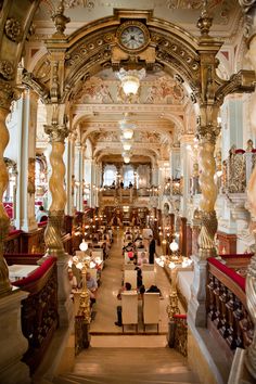 an ornately decorated building with many tables and chairs