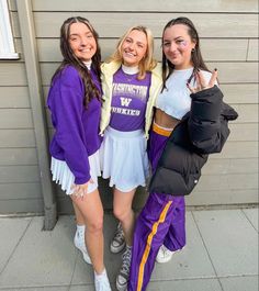 three girls in purple and white outfits posing for the camera