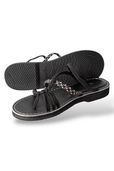 a pair of black sandals on top of each other