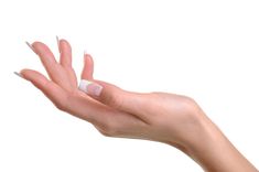 a woman's hand with white nail polish holding something in her left hand, against a white background