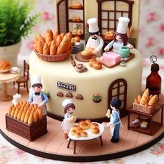 there is a cake that has some people making breads on the top of it