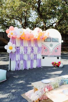 a vw camper van decorated with balloons and streamers for a birthday party