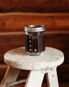 a mason jar sitting on top of a wooden stool