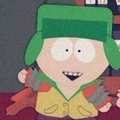 a cartoon character wearing a green hat and scarf