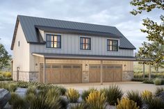 a two car garage with three windows on the top floor and an attached living area