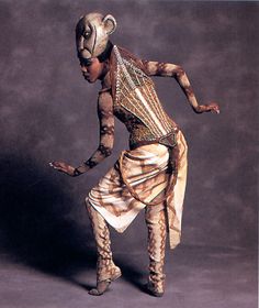 a woman dressed in an animal costume is dancing with her legs spread out to the side