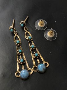 Gold tone turquoise beaded stones 4.5cm drop earrings 1960s 1970s jewellery Retro Blue Drop Earrings Jewelry, Retro Blue Drop Earrings, Retro Blue Earrings For Pierced Ears, Vintage Turquoise Earrings With Dangling Beads, Retro Pierced Drop Earrings, Vintage Pierced Drop Beaded Earrings, Vintage Blue Dangle Earrings, Vintage Blue Dangle Jewelry, Vintage Metal Chandelier Earrings With Dangling Beads