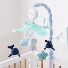 Our Sealife Musical Mobile brightens the nursery while helping to promote baby's auditory development, motor skills and visual stimulation. Our expertly designed nursery must-have features plush velour whales, a dolphin, octopus, and starfish characters in various blue tones under scalloped aqua arm covers. The digital music box plays snippets of 12 different lullabies to soothe your little one gently to sleep. Easily switch music on/off or between songs with the simple touch of a button. Two ve Nursery Themes Simple, Marine Themed Nursery, Boho Beach Nursery Boy, Ocean Themed Baby Room, Baby Room Ocean Theme, Ocean Theme Nursery Boy, Ocean Nursery Baby Boy, Under The Sea Baby Room, Coastal Nursery Boy