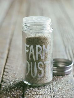 a jar filled with sand sitting on top of a wooden table