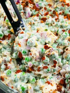 a close up of a bowl of food with peas and other toppings on it