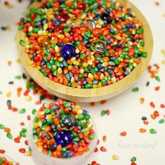 a wooden spoon filled with colorful candy sprinkles on top of a table