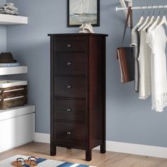 a chest of drawers in a room with blue walls