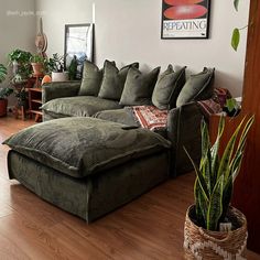 a living room filled with lots of green furniture