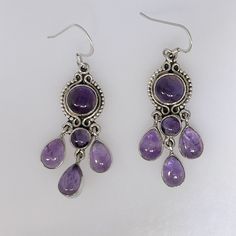 This Is A Lovely Pair Of Amethyst Earrings. Chandelier Style, They Dangle 2.25" With Bale. As Shown In Photos, Amethysts Are A Pleasant Medium Purple Color, Slightly Included But Not Opaque. Cabochons Measure Approximately 6-9mm (Rounds) And 9x7mm Pears. The Earrings Weigh 12.124 Grams. New, No Tags. All Stamped "925". Ess-359 Silver And Purple Earrings, Amethyst Earrings Aesthetic, Purple Wedding Accessories, Silver Gemstone Chandelier Drop Earrings, Silver Gemstone Drop Chandelier Earrings, Silver Cabochon Dangle Earrings, Whimsigoth Earrings, Whimsigoth Outfits, Handmade Evil Eye