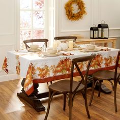 a dining room table is set with plates and cups