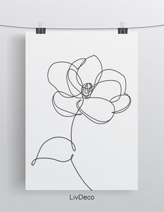 a line drawing of a flower on a white paper with clothes pins hanging from it