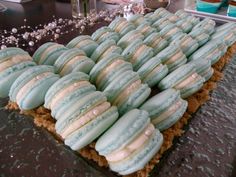 there are many blue and white macaroons on the table