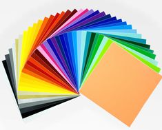 many different colors of paper on a white background