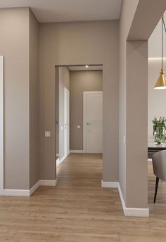 an empty room with hard wood flooring and white trim on the walls is shown