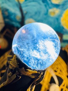 a blue glass object sitting on top of a wooden table