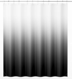 a black and white shower curtain hanging on a wall