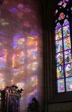 sunlight streaming through the stained glass windows in a church