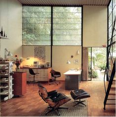 a living room filled with furniture and lots of windows