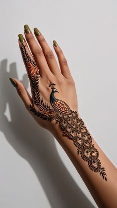 a woman's hand with henna tattoos on it