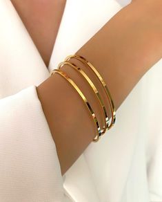 "The Gold Simple Plain Triple Bracelets 3x Set is perfect for everyday wear.  Crafted from stainless steel with a non-tarnish gold finish, these bracelets have two sizes options: 19cm(7.5\") and 20cm(7.9\") circumference.  They feature plain design and are easy to combine with any outfit.  Ideal for women who want to stay on trend, these triple bracelets will add a touch of glamour to your look. You can use them anytime in your daily life as they're resistant to tarnishing even when exposed to s Cheap Classic Round Bangle, Gold Bangle Bracelets, Plain Gold Bangles, Gold Bangles For Women, Gold Bangle Set, Gold Bracelet Set, The Bangles, Bracelets Design, Tarnished Jewelry