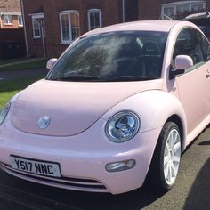 a pink car parked in front of a house