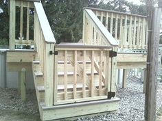 there is a wooden play set with stairs and railings on the side of it