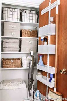 the closet is organized with baskets, towels and other items for storage in order to keep clean