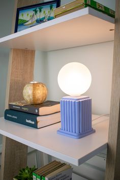 a lamp sitting on top of a book shelf