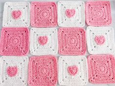 nine crocheted squares with hearts on them in pink and white, arranged together