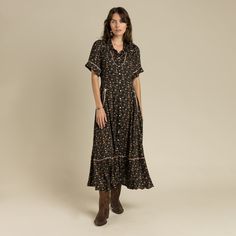 A pearl snap, silky, Western cut dress with contrast piping and arrow patches at welt pockets. This western floral print is on a black ground, with sepia, peach, and orange tones - referencing it's name sake. The Dahlia. Country & Western Dresses, Dark Prairie Dress, Western Striped Dress, Bkack Western Dress, Black Dress With Western Boota, Black Ground, Cut Dress, Orange Tones, Contrast Piping