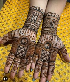 two hands with henna designs on them