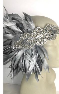 Gatsby Headpiece -Halloween- Silver Feather Headdress - Head Wrap- 1920 Hair Accessory-Speakeasy- Handmade in USA- Charleston Hello,  This feather  head wrap is made with goose feathers. I first made it for a customer so I'm naming it after her, "The Geri" The rhinestone piece measures about 6" wide and the feathers are 6-7" long . I can make them any size.  They are placed on a stretch band that fits any adult head size and very comfortable.  Other Feather Colors available in: Gold Silver (shown) white ivory pink red  See chart for Elastic colors. If you need a special color let please let know. --------------------------------------------------- I am based in the NYC metropolitan area where I started with a shop in Soho.  I make quality accessories with vintage inspire ornaments. I love Wide Art Deco Head Band, Luxury Feathered Evening Headpieces, Luxury Formal Feather Headpieces, Luxury Vintage Fitted Headpieces, Gatsby Style Feather Trim Headpiece For Evening, Flapper Evening Headpiece With Feathers, Feather Trim Headpieces For Carnival Evenings, Feather Trim Headpieces For Evening Carnival, Feathered Evening Headpieces For Carnival