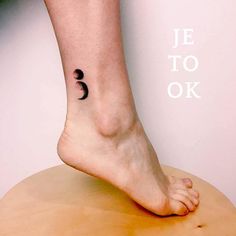 a person with a small tattoo on their foot that reads je to ok and the word je to ok