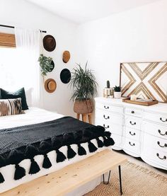 a bedroom with black and white decor on the walls