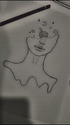 a drawing of a woman's face with stars and planets above her head, on a sheet of paper